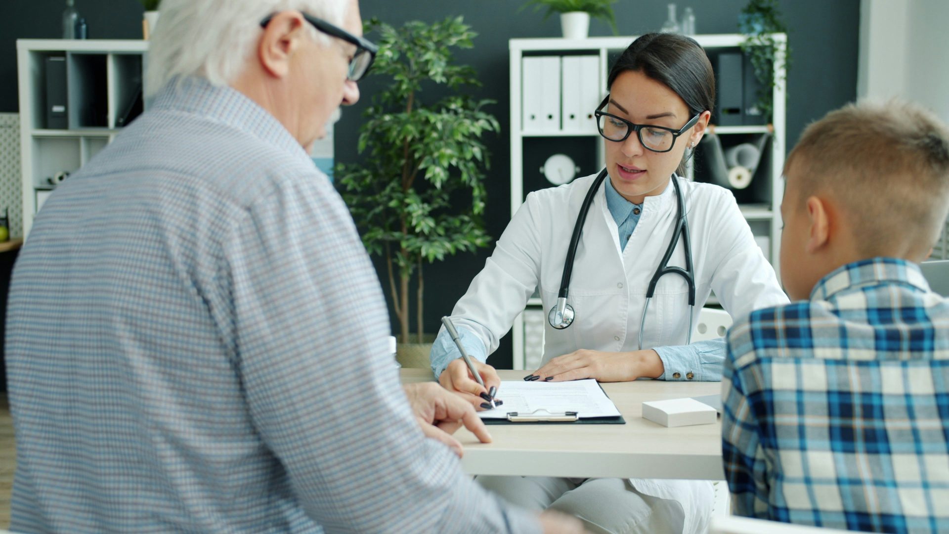 Médico atendiendo a un anciano y a un niño.